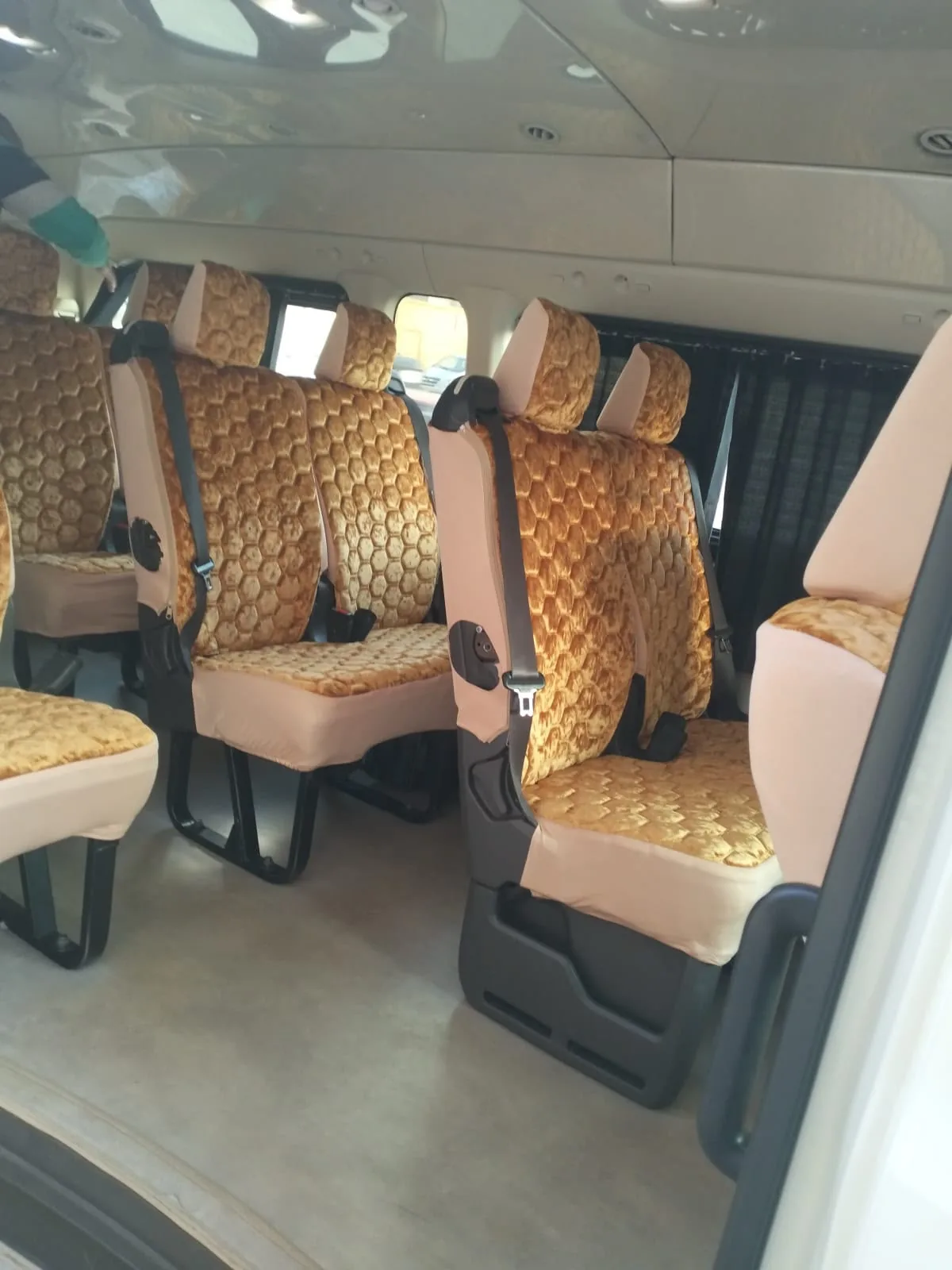 An interior view of minibus seating and aisle.