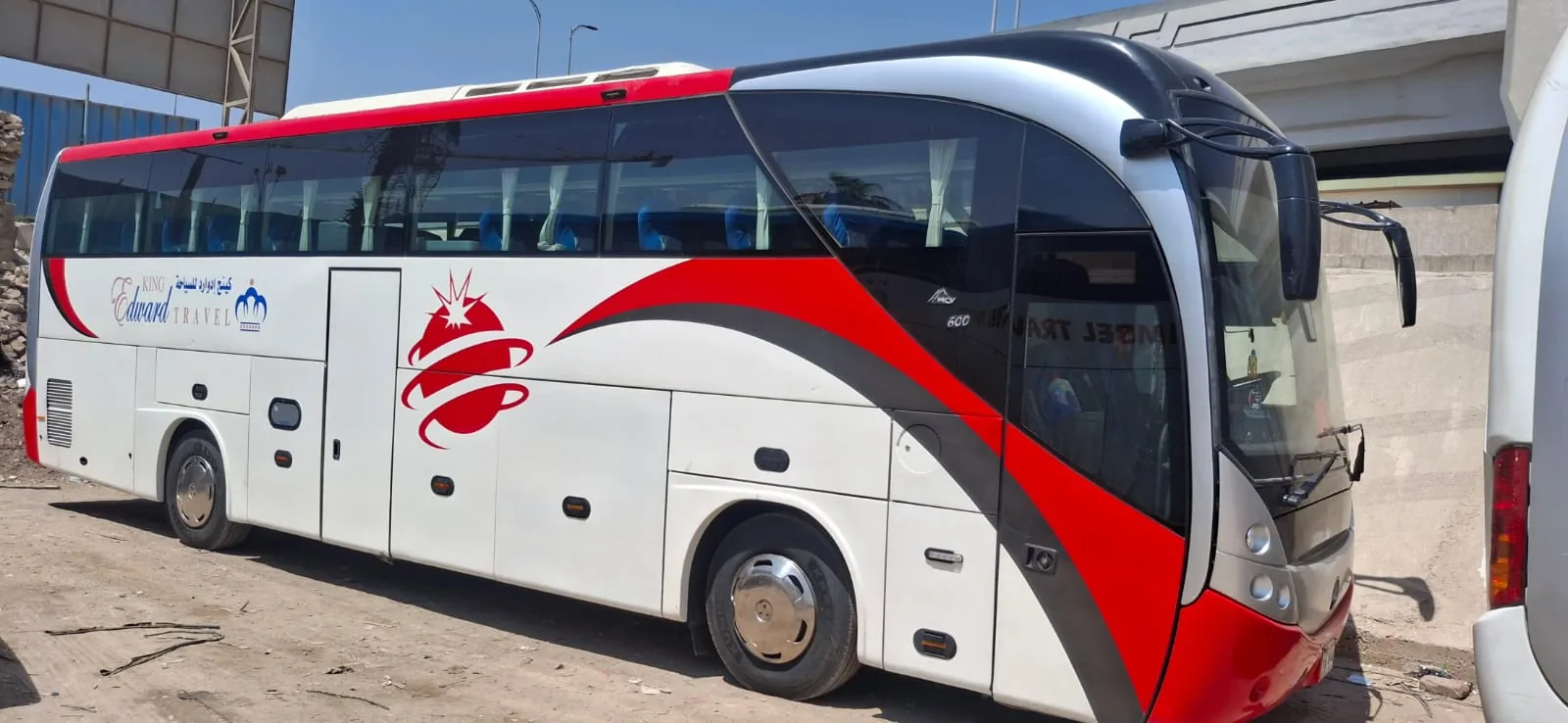A tourist coach with a white and red exterior.